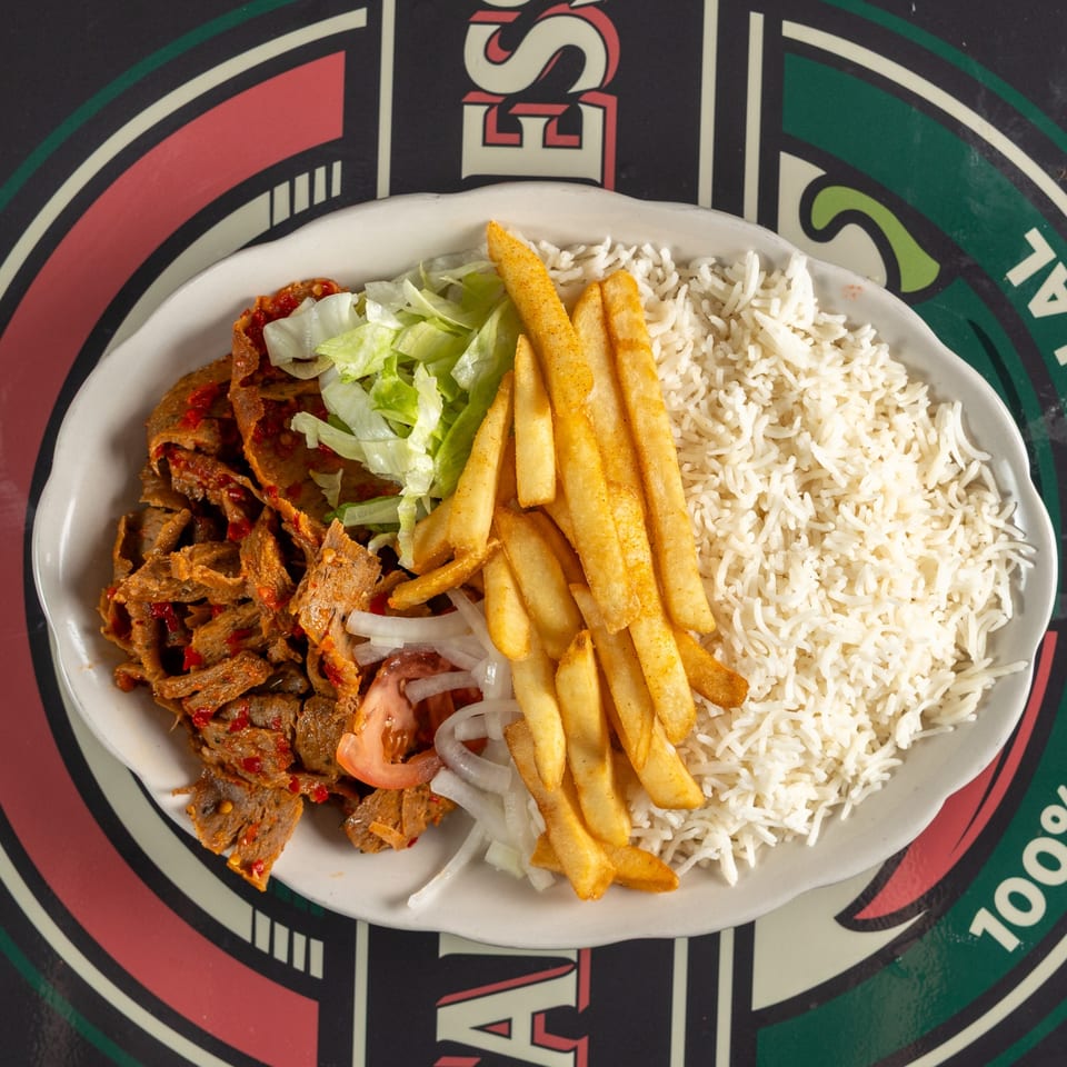 Gyro meat with rice, fries, lettuce, tomato, and onion.